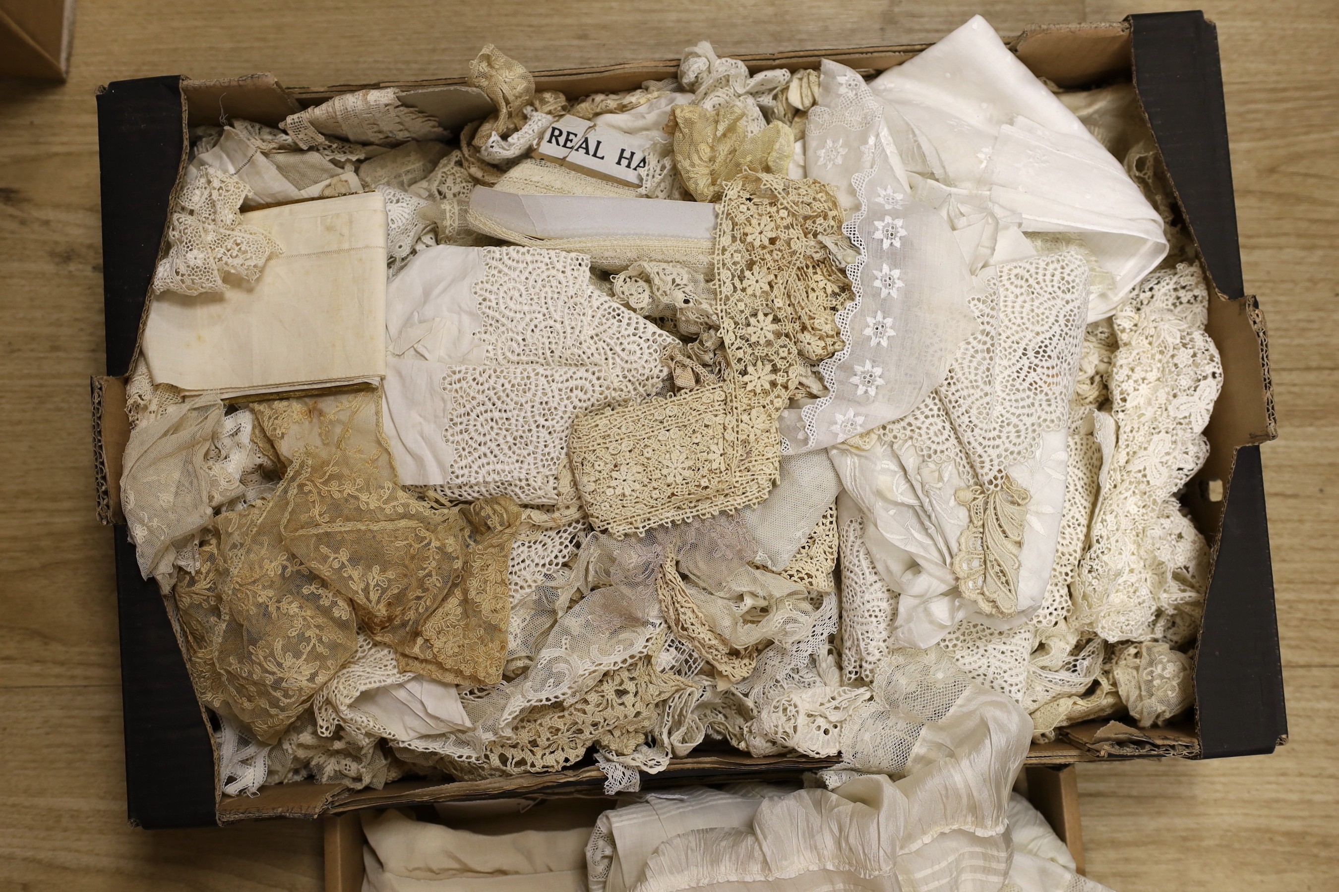 A quantity of mixed machine and some handmade lace including Irish crochet, together with a white work petticoat, silk christening gown and a silk shawl